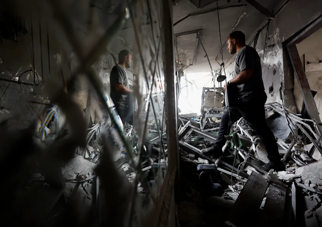 A Palestinian man inspects the site of an Israeli airstrike on a residential building on Tuesday, in Gaza City, May 27, 2026. 