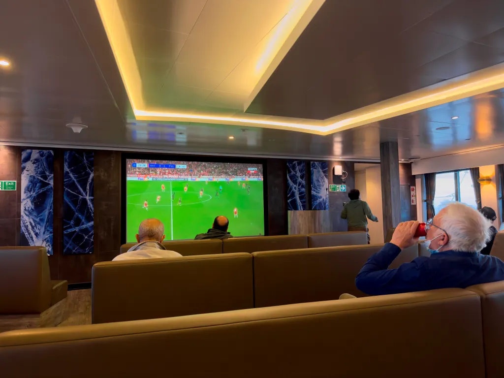 Passengers on the Hantavirus-stricken cruise ship, MV Hondius, watch a football match on a television during their voyage to Spain's port of Tenerife.