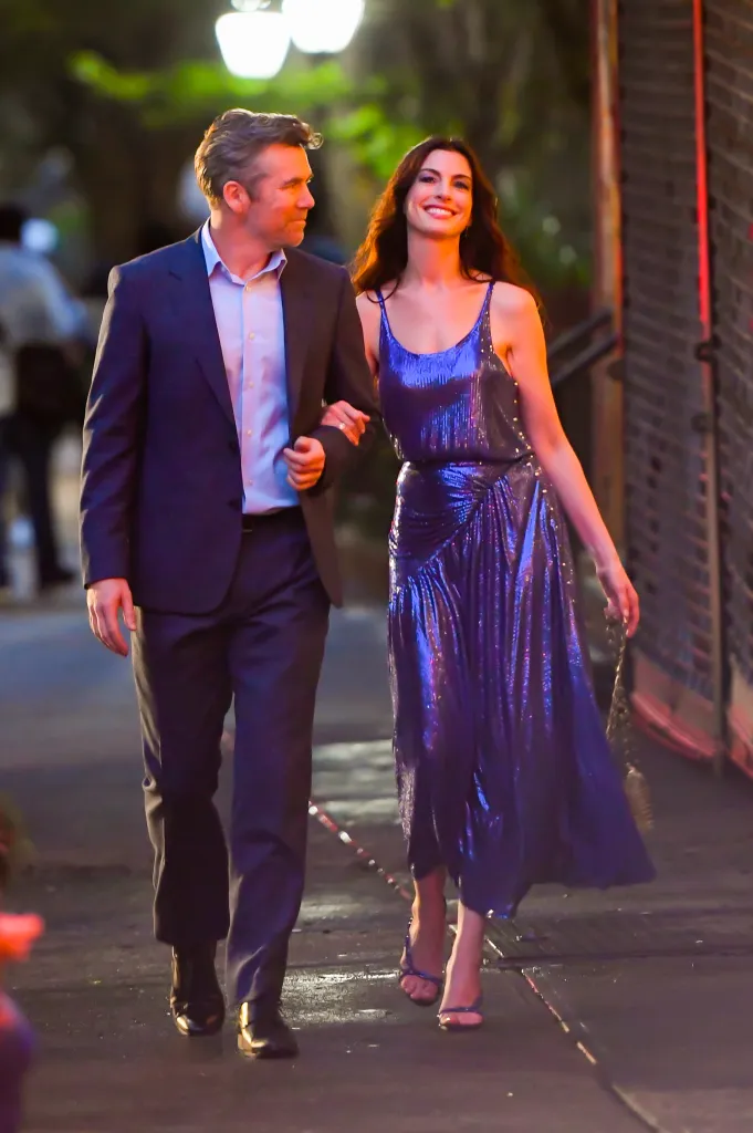Patrick Brammall and Anne Hathaway walking arm in arm.