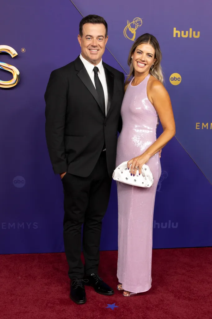 Carson Daly and Siri Daly posing on the red carpet.