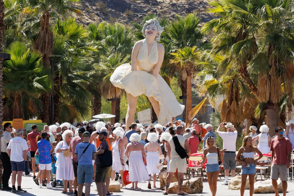 People dressed as Marilyn Monroe gather around the 