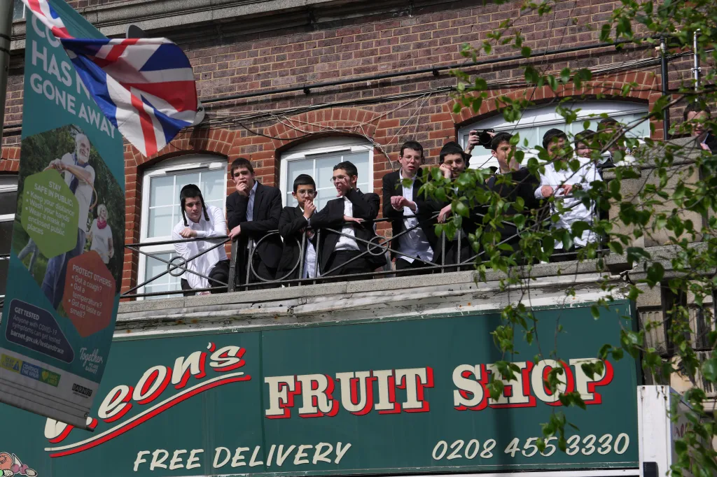 People look over the area where two people were stabbed in Golders Green neighborhood, London.