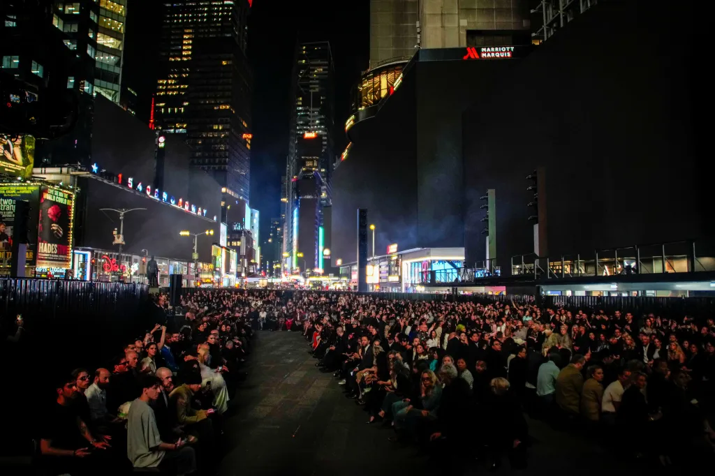 People waiting for the start of the Gucci Cruise 2027 collection at Times Square in New York City.