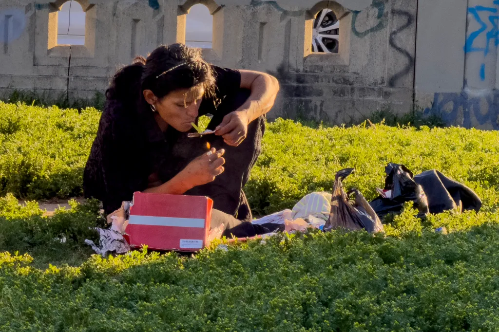 Person smoking from a drug pipe in MacArthur Park.