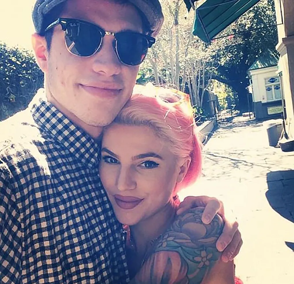 Carly Aquilino and Pete Davidson smiling as he hugs her.