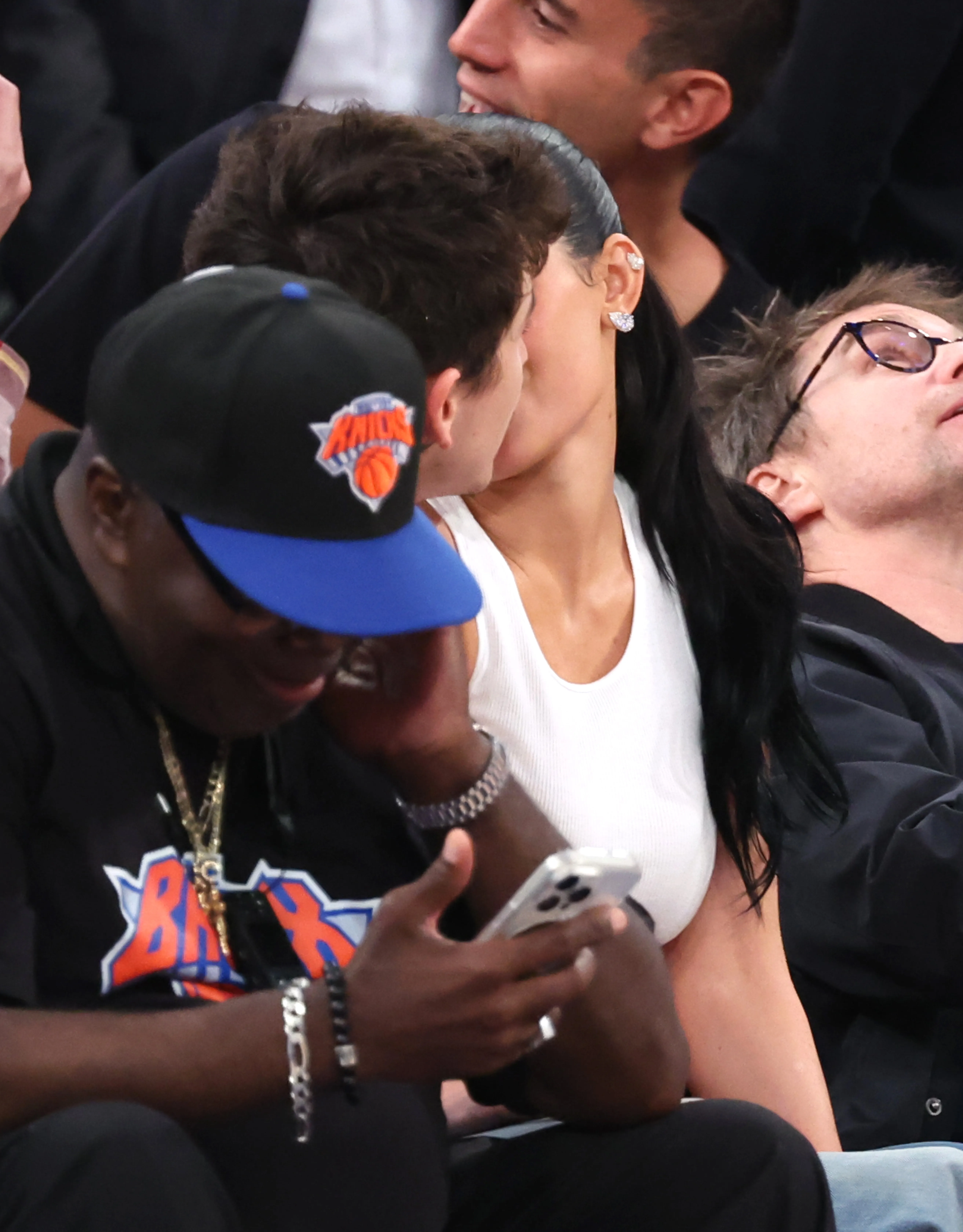 Kylie Jenner and Timothée Chalamet kissing on celebrity row during an NBA game.