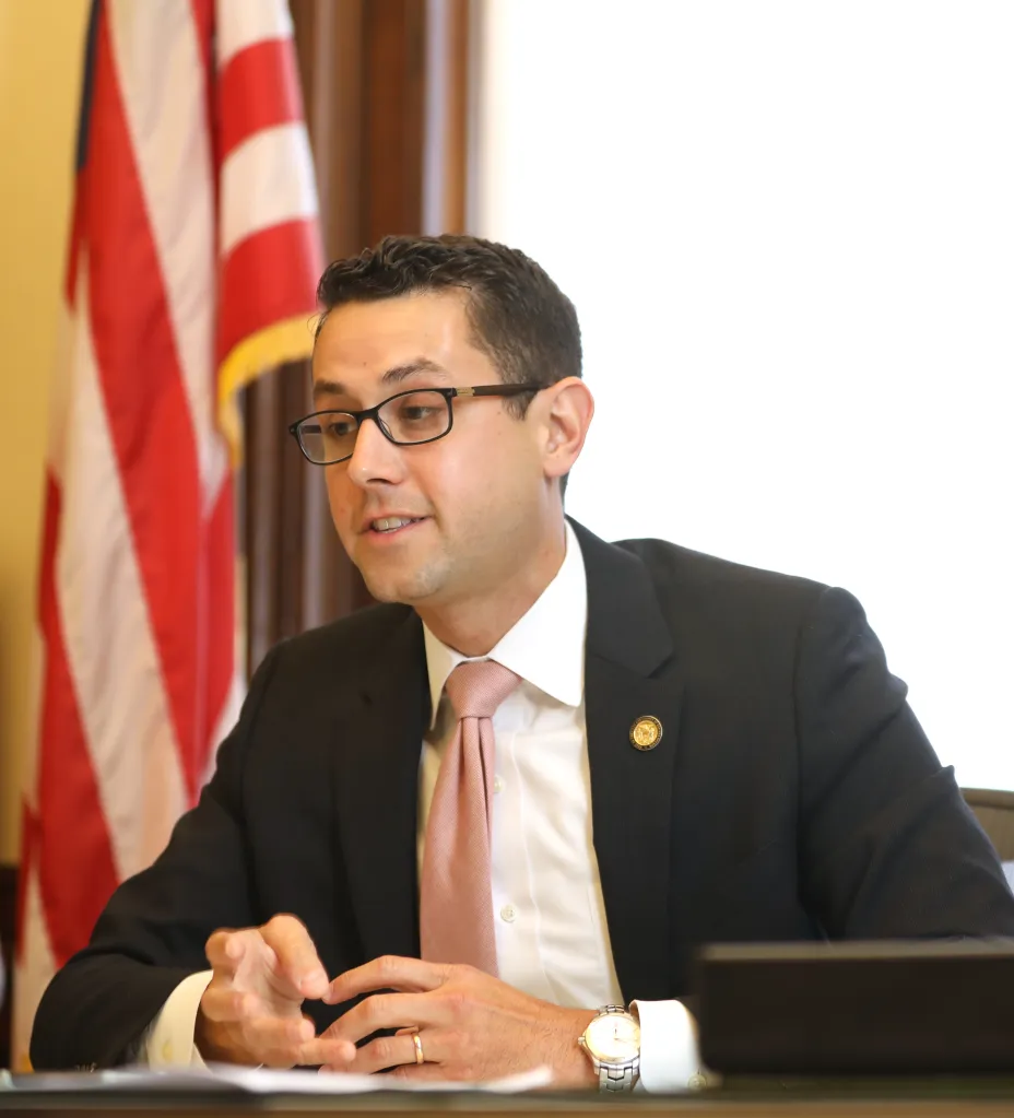 Chief of staff Jason Elliott talks about his work in his office.