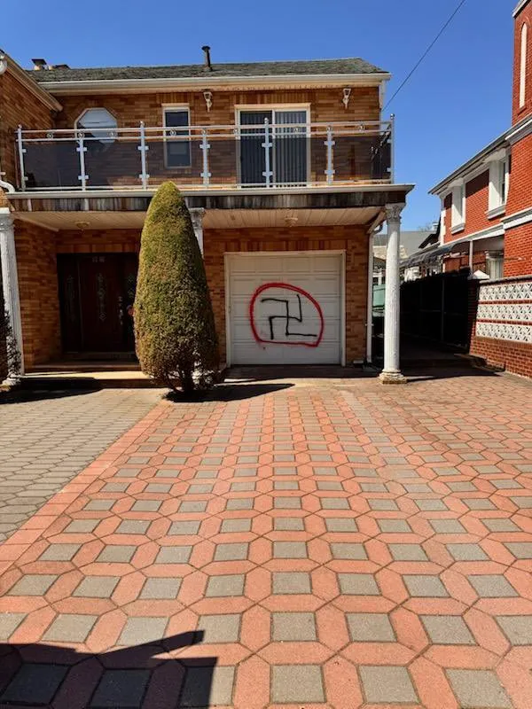 Swastika graffiti on a garage door of a private home.