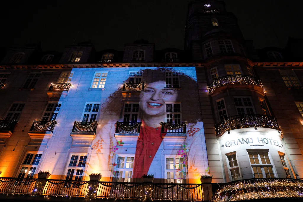 A picture of Mohammadi is projected onto the side of the Grand Hotel in Oslo, Norway, before the Nobel banquet on Dec. 10, 2023. 