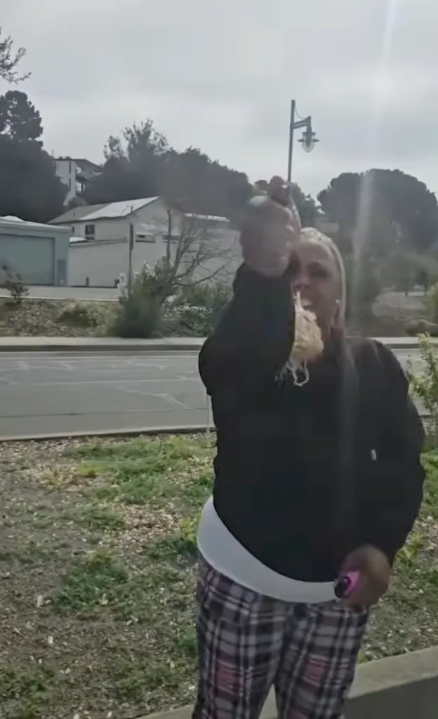 Tiffany Bagby holds a can of pepper spray with her right hand and another object in her left hand, facing the viewer with a blurred background.