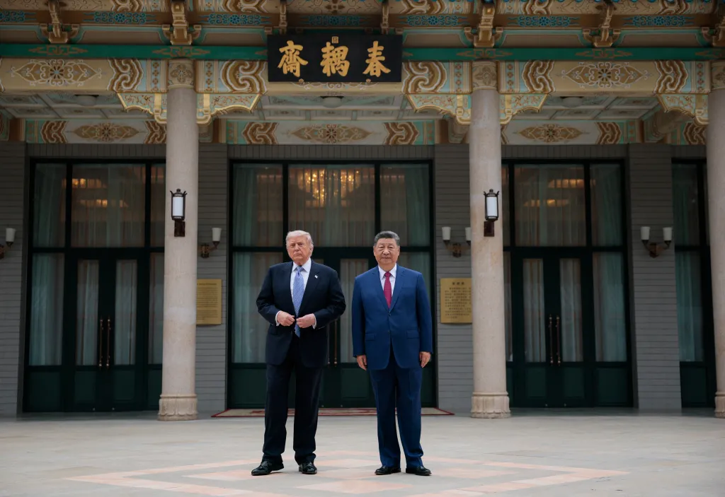US President Donald Trump and China's President Xi Jinping posing in front of a traditional Chinese building.