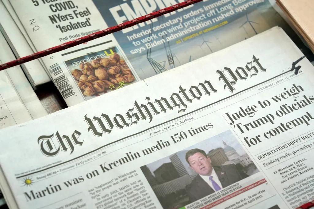 The Washington Post newspaper on a newsstand, with a headline 