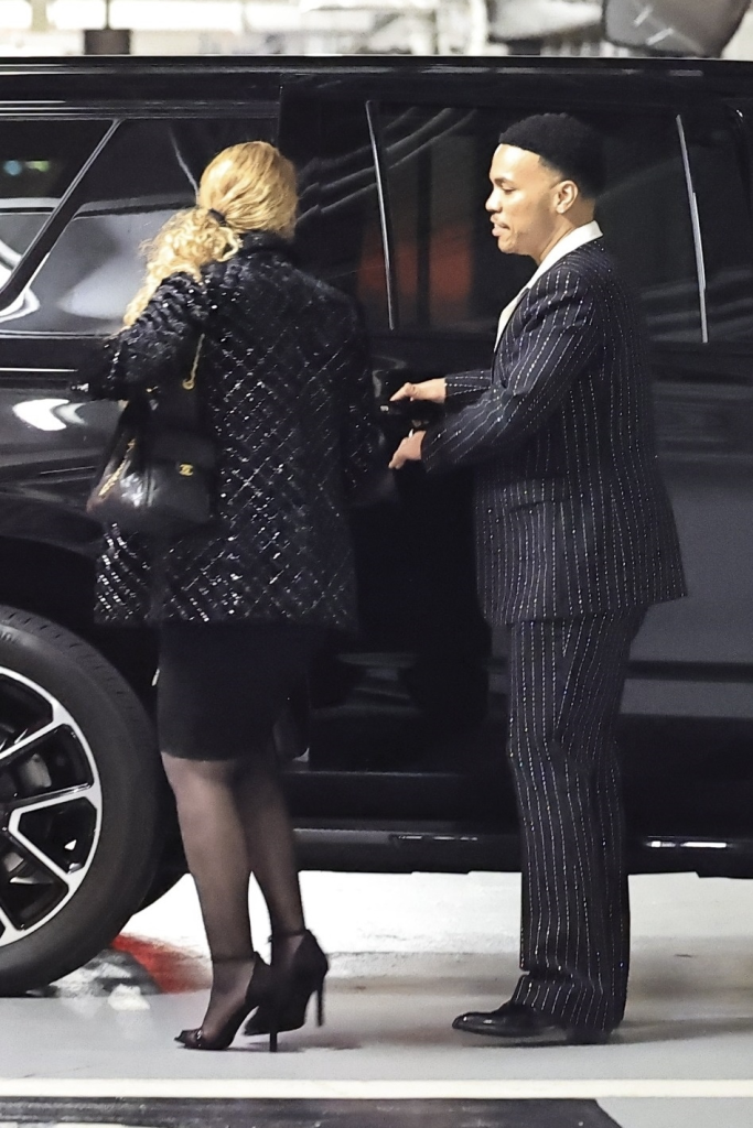 Mariah Carey and Anderson .Paak getting into a car.