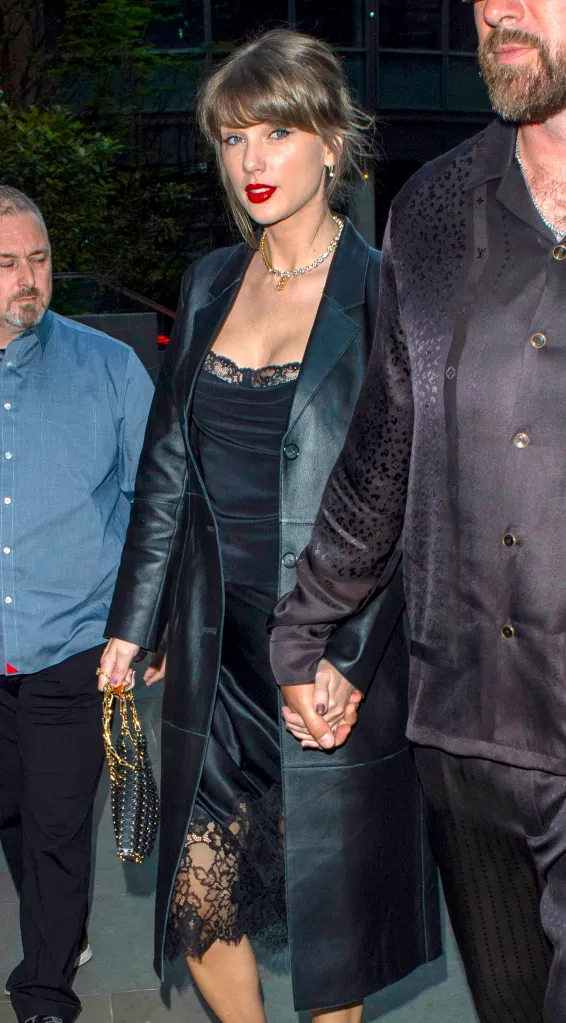 Taylor Swift and Travis Kelce holding hands while dining at Lucky Cat restaurant in London.