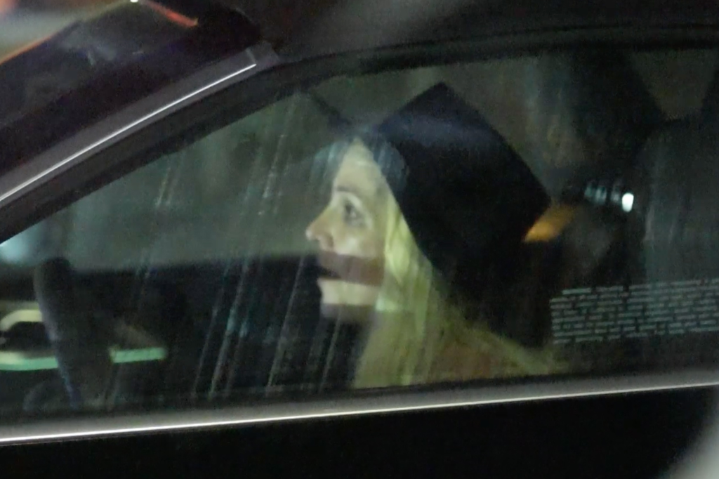 Britney Spears in her car, with an open mouth expression, looking to the right.
