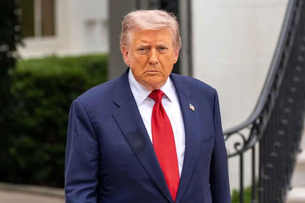 Donald Trump in a navy suit and red tie.