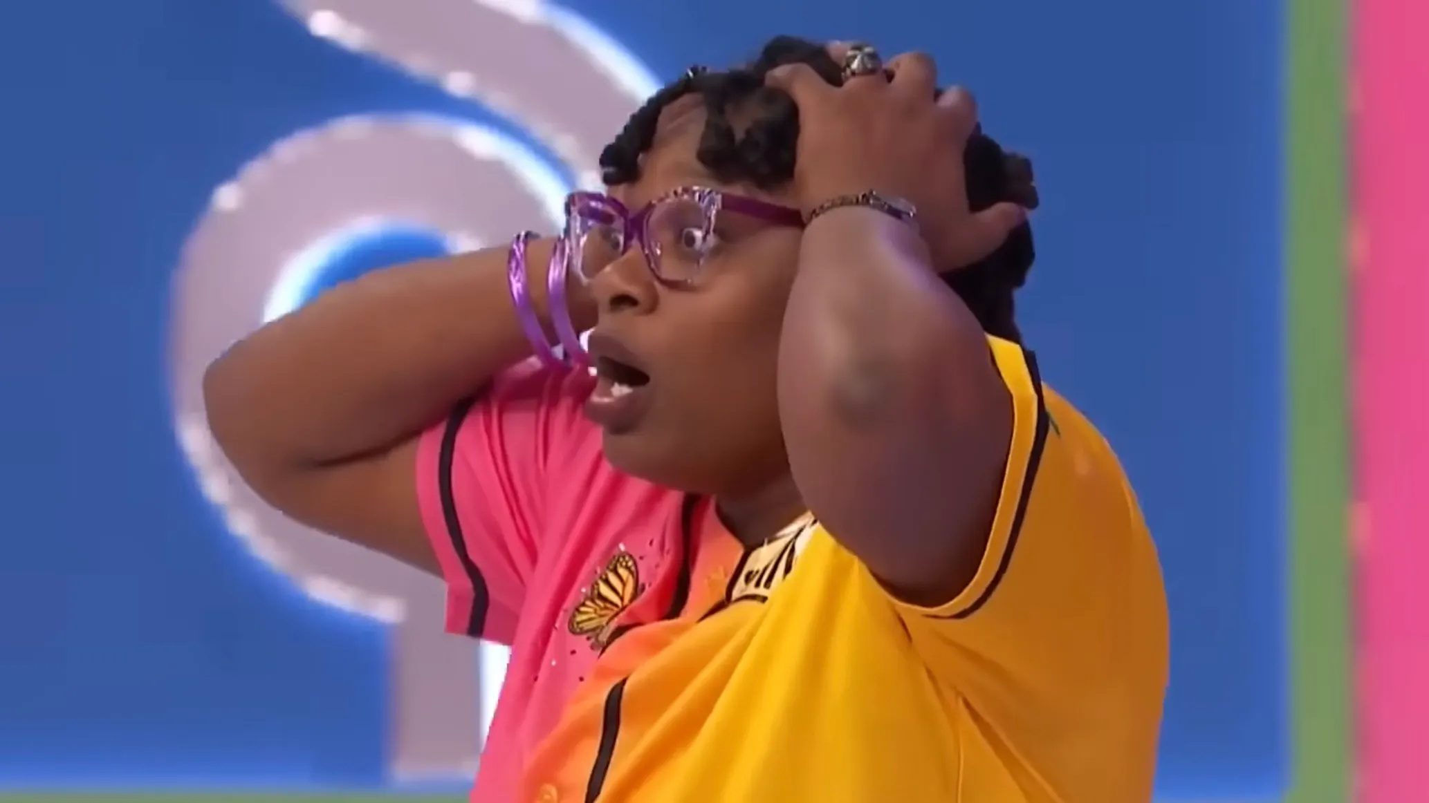 Vanessa from Price Is Right with her hands to her head in shock.