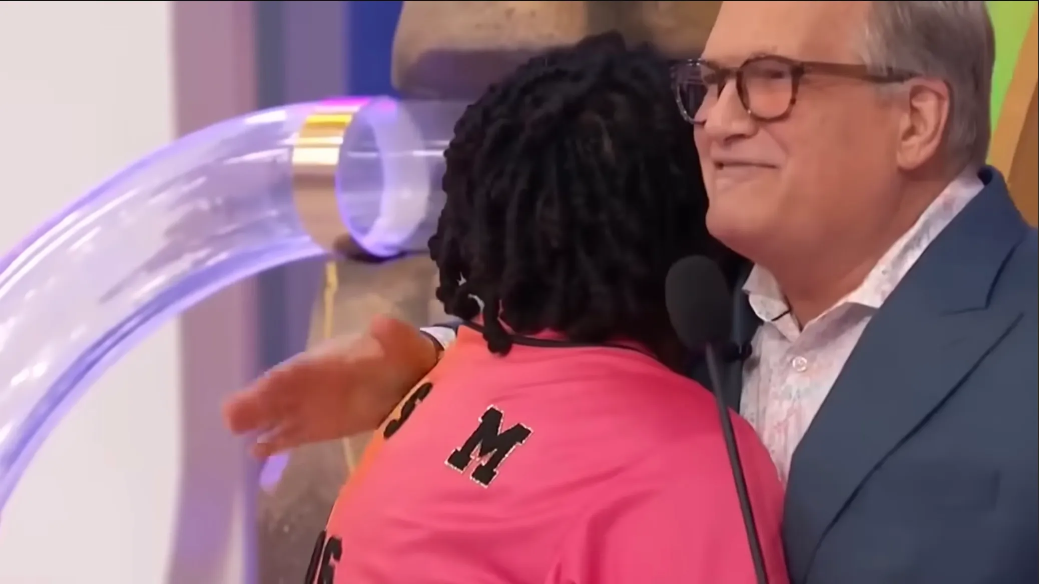 Vanessa Wings hugging the game show host after her victory.