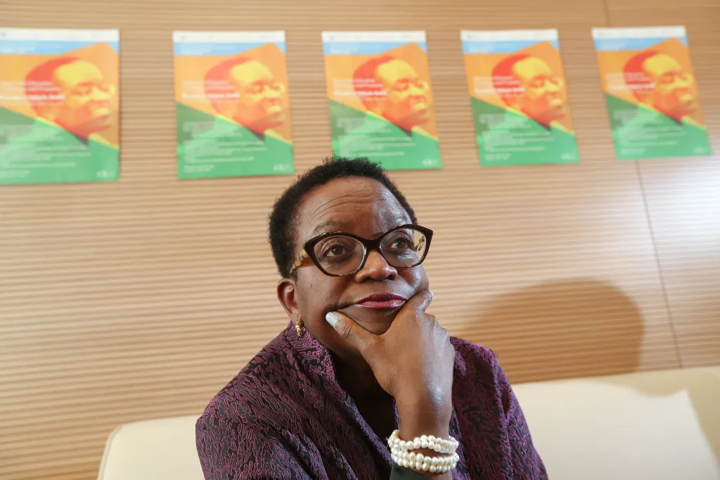 Professor Valerie Smith, President of Swarthmore College, wearing glasses and a purple top, with her hand on her chin.