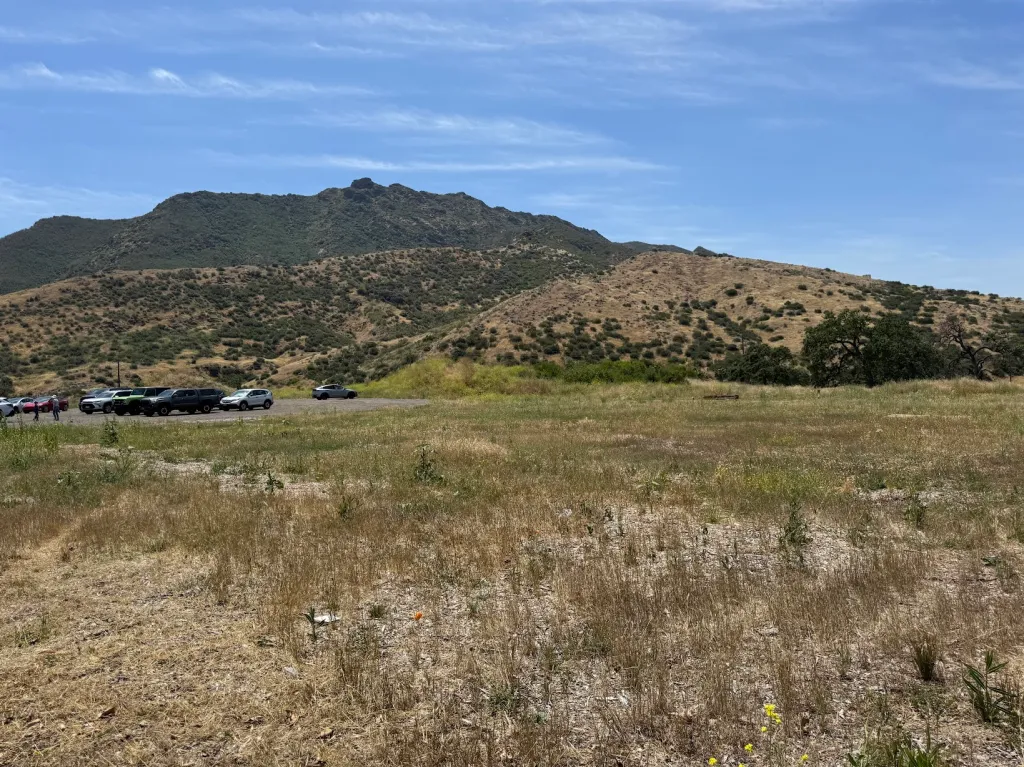 Cars parked along Kanan Road in Agoura Hills, with brush-covered mountains in the background.