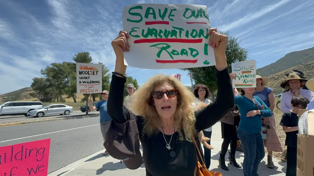 A woman holding a sign that says 