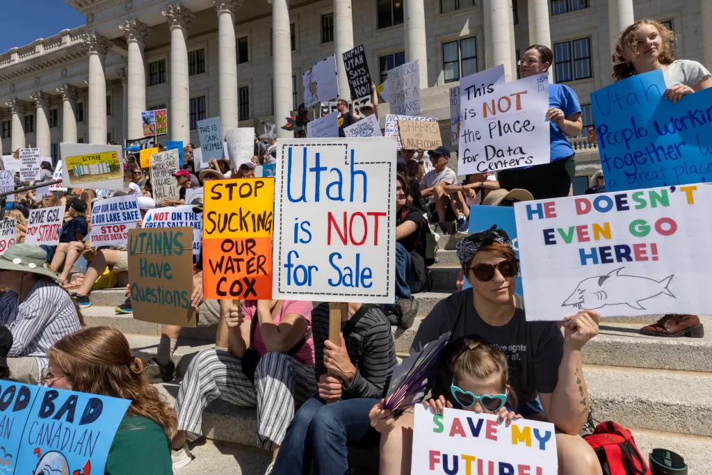 Protesters hold signs against the proposed Stratos data center in Salt Lake City, Utah, with signs such as