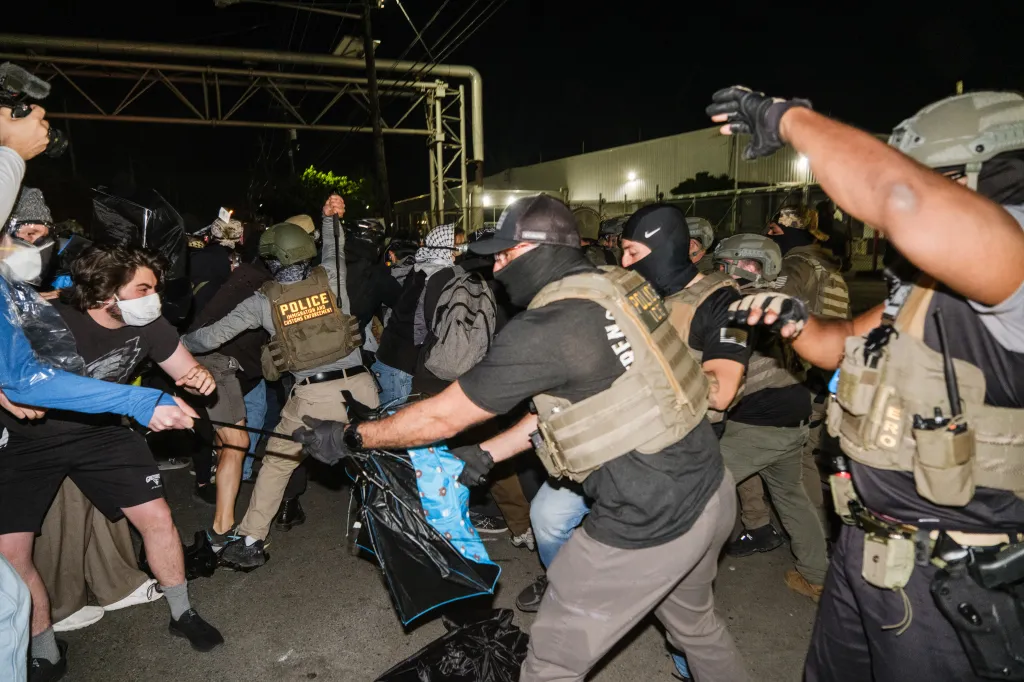 Police and protesters clashing outside Delaney Hall, a detention facility.