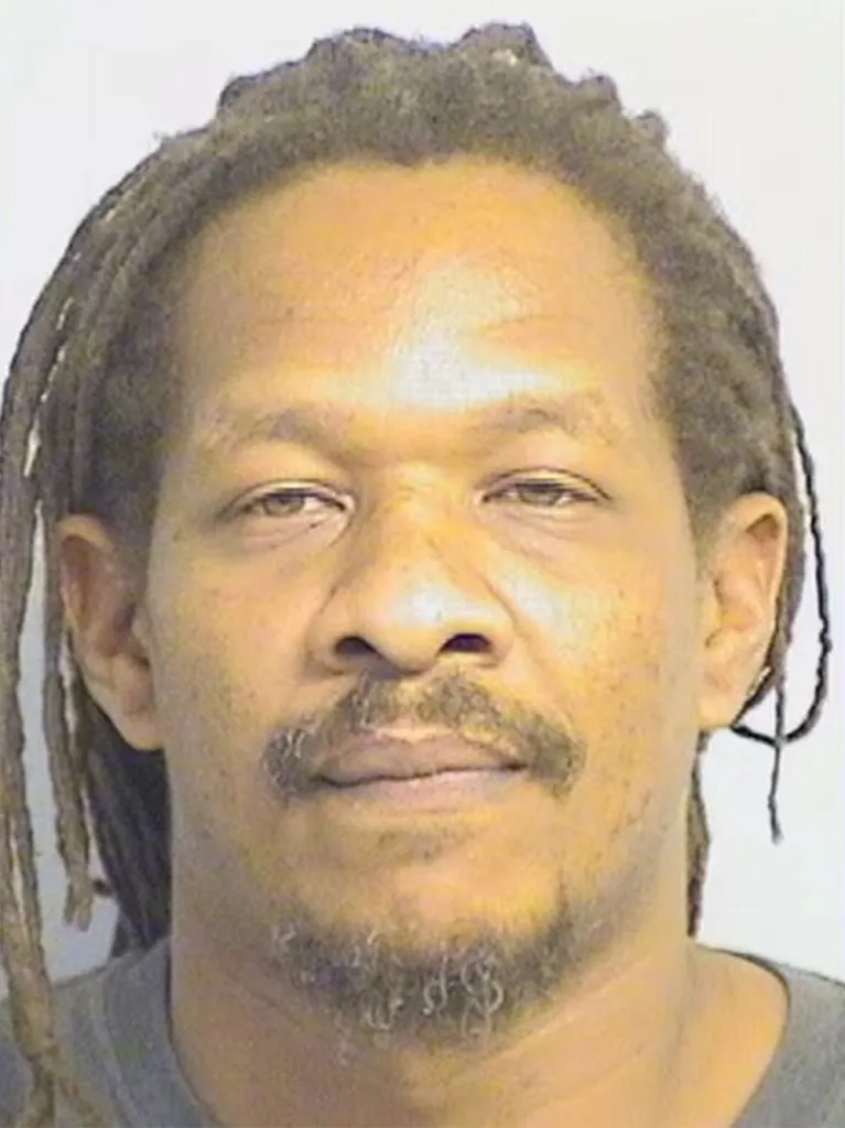 Mugshot of Randall Lendell Dejourney, a 44-year-old Black man with dreadlocks, mustache, and goatee.