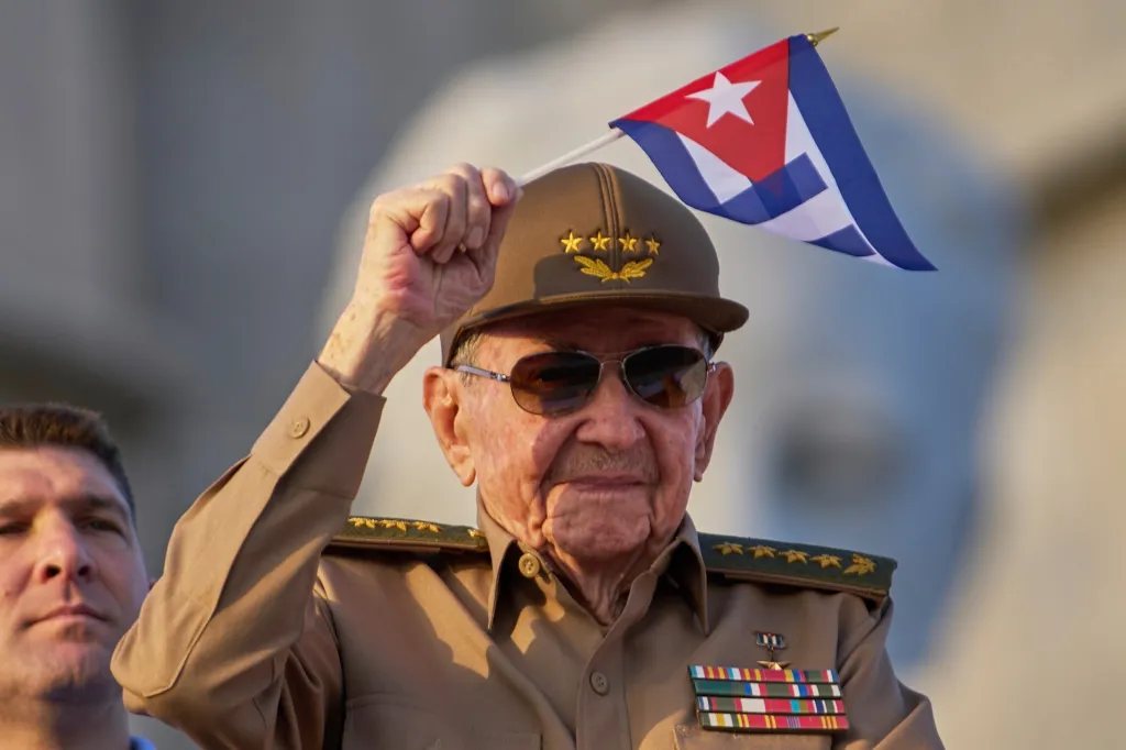 Raul Castro waves a Cuban national flag.