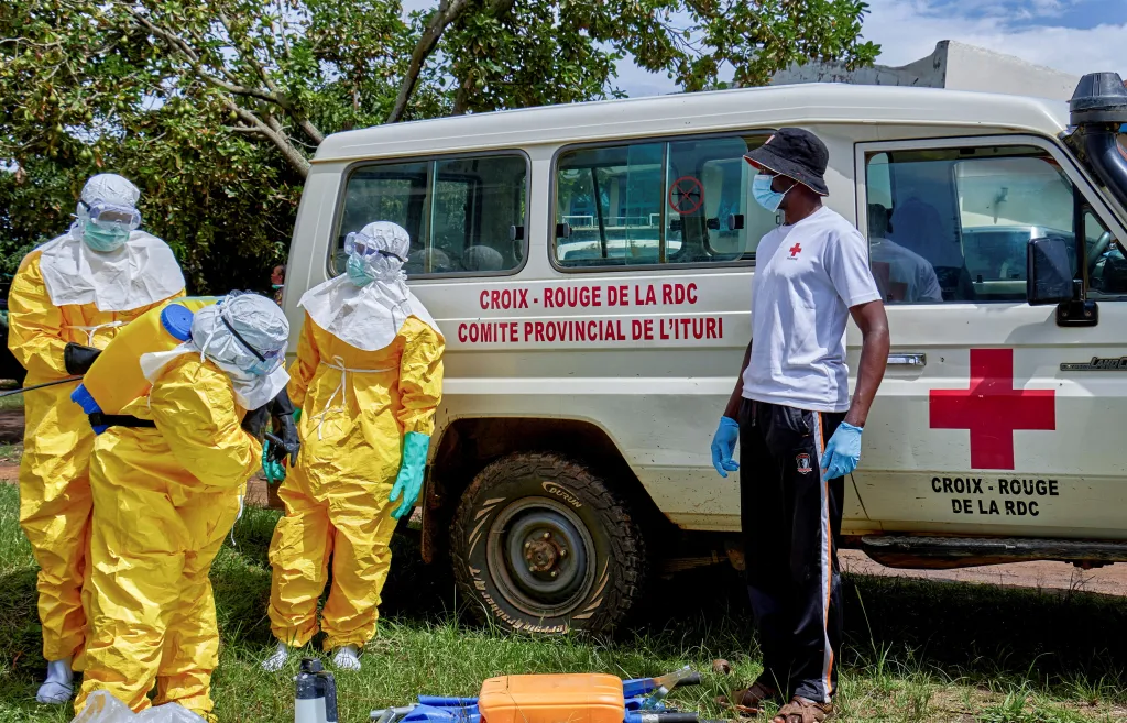 Red Cross workers disinfecting after handling the body of a person who died of Ebola in Bunia, Ituri province, Democratic Republic of Congo.