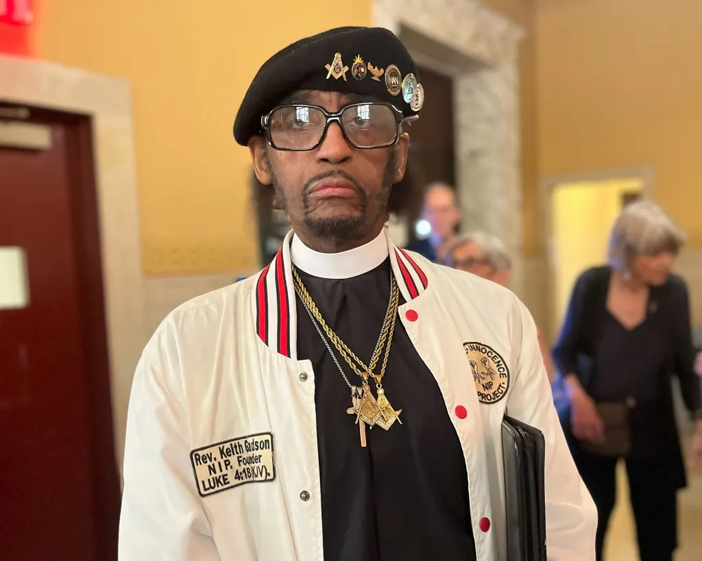 Rev. Keith Gadson wearing a white jacket with an 