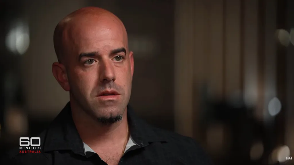 Dominic Cascio, a bald man with a goatee, looking slightly down and to the left.