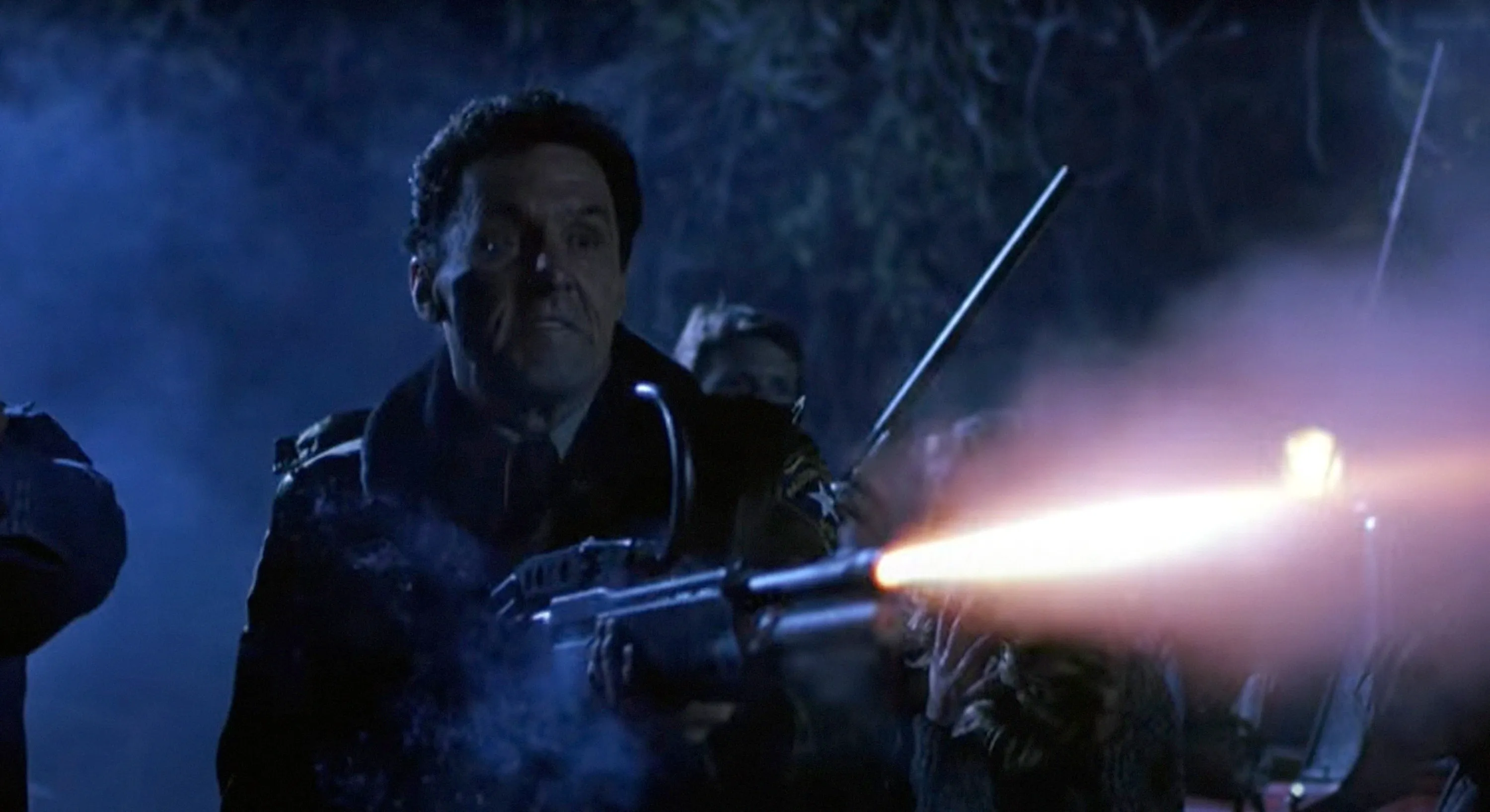 Beau Starr as Sheriff Ben Meeker firing a shotgun in a still from 
