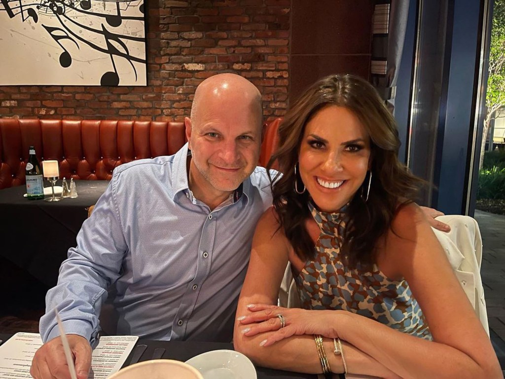 Jennifer Fessler and a man sitting at a restaurant table.