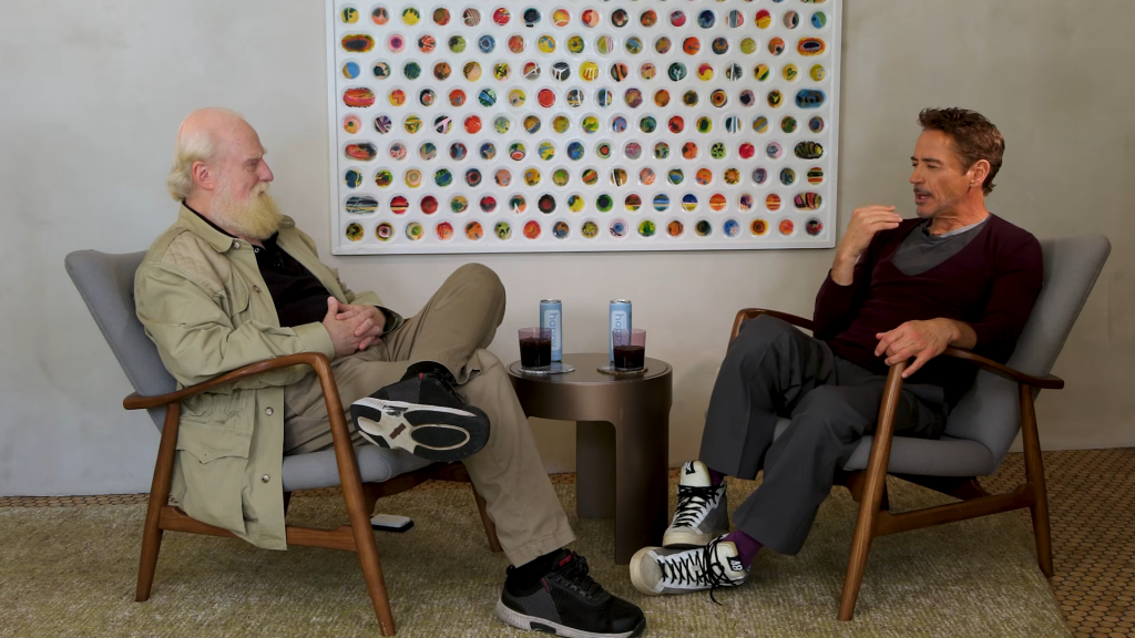 Robert Downey Jr. talking with an interviewer, both sitting in chairs.