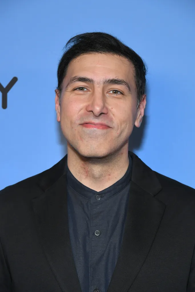 Ramtin Arablouei smiling, wearing a dark shirt and black jacket.