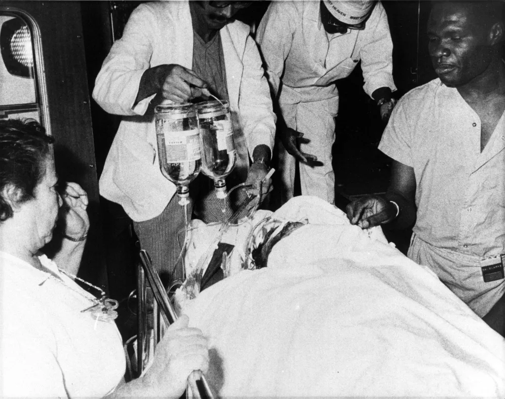 Medical personnel rushing shooting victim Robert Violante into a hospital.