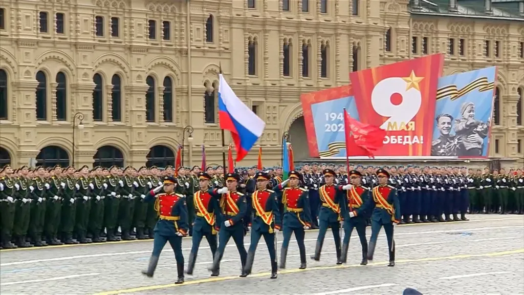 Russian service members march in formation during a military parade in Red Square.