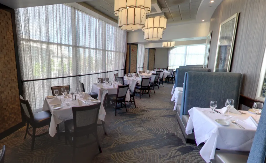 Dining room with tables and chairs set at Ruth's Chris Steakhouse in Walnut Creek, CA.