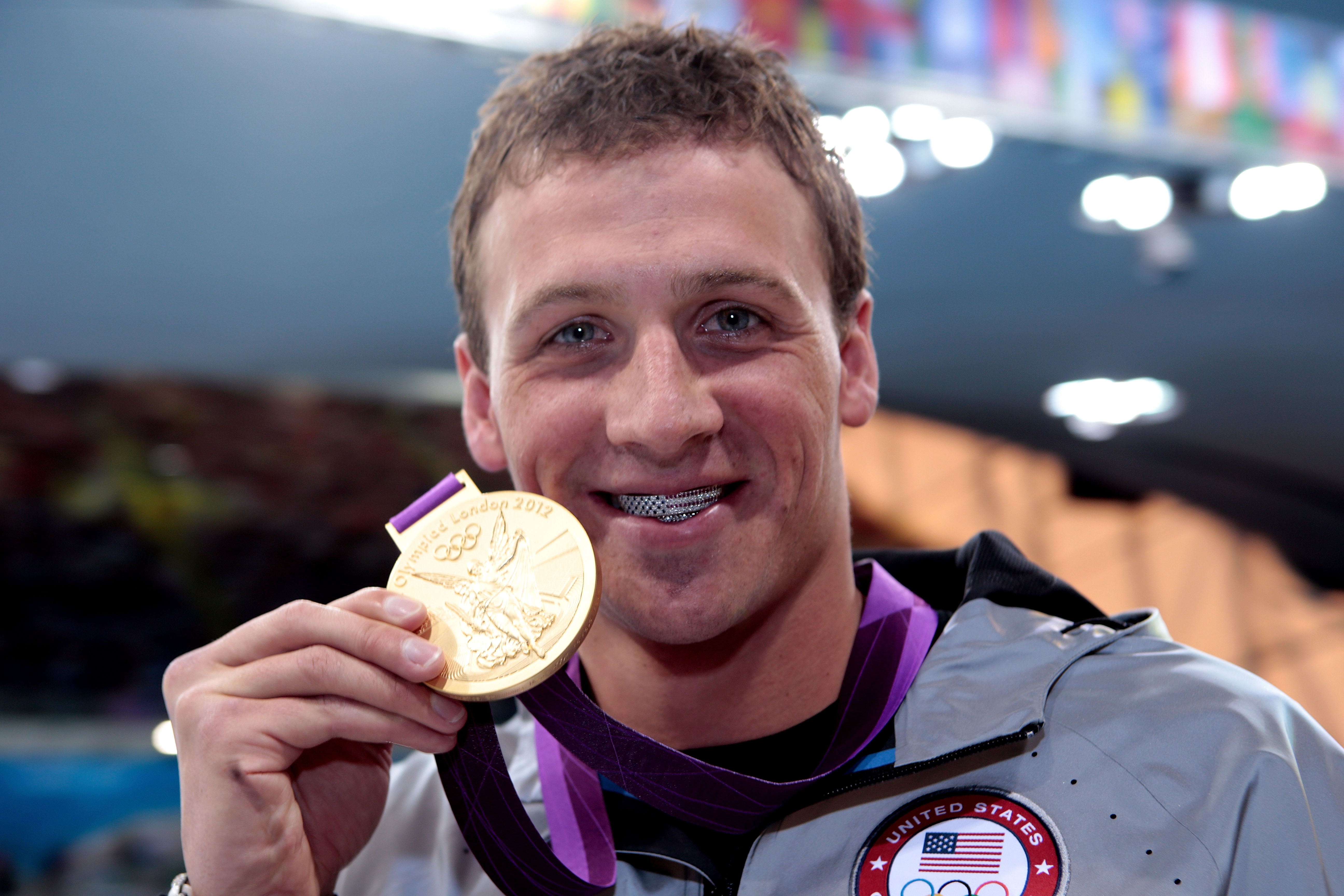 Ryan Lochte of the United States celebrates with his Gold Medal.