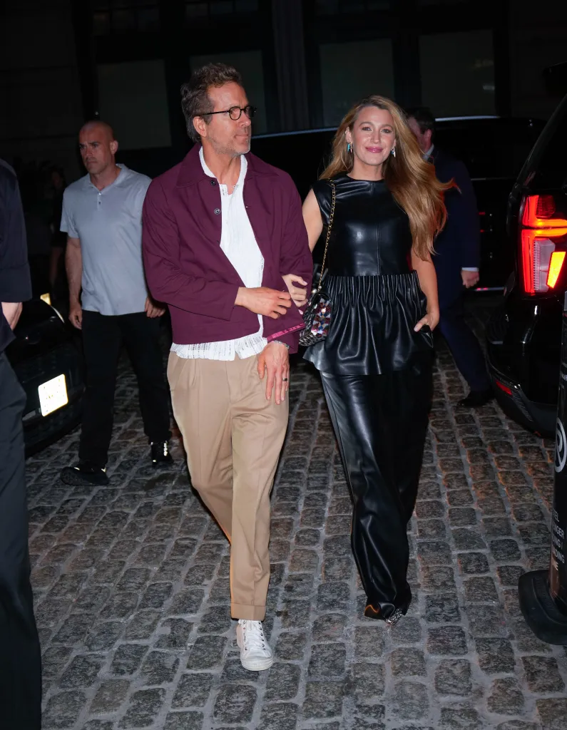 Ryan Reynolds and Blake Lively walking together on a cobbled street.