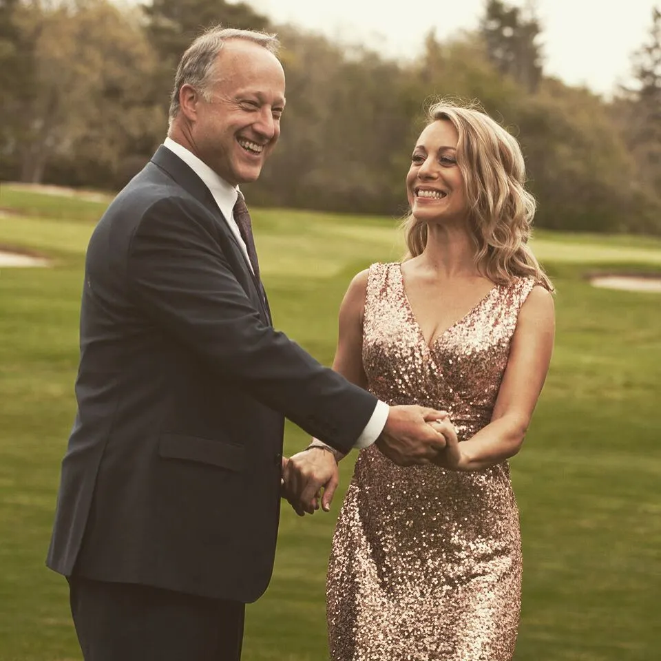 Samuel MacAusland and Janette MacAusland holding hands and laughing.