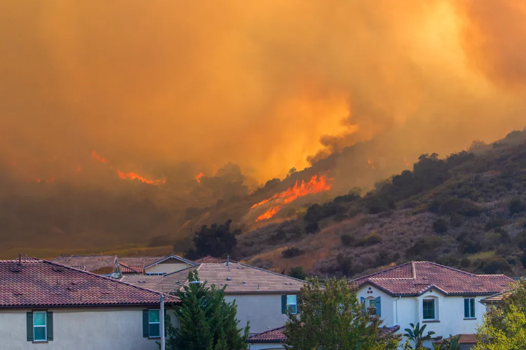 The Sandy Fire burns on a hill behind a residential area in Simi Valley, California.