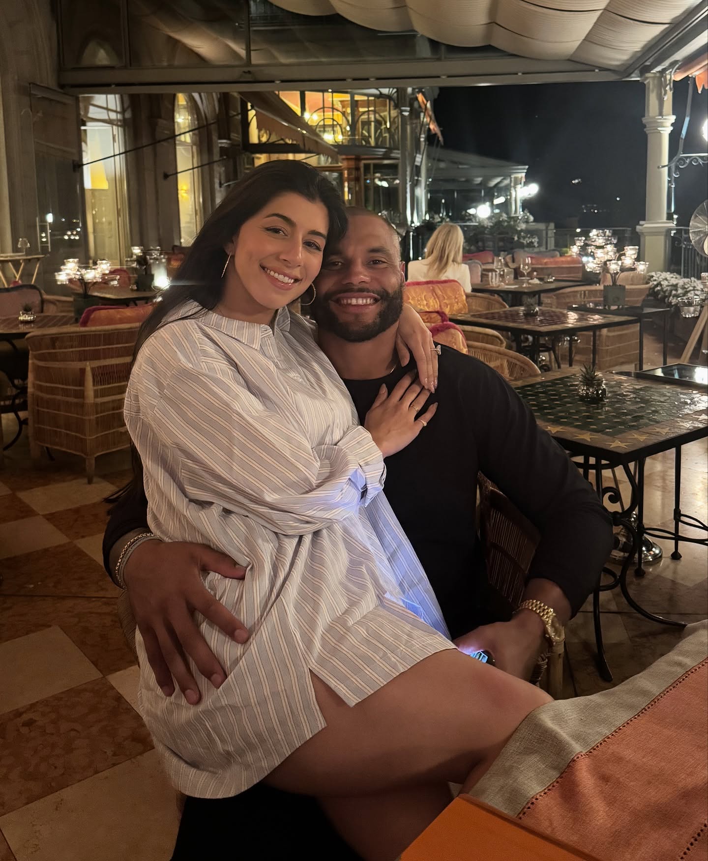 Sarah Jane Ramos and Dak Prescott posing together at a restaurant.