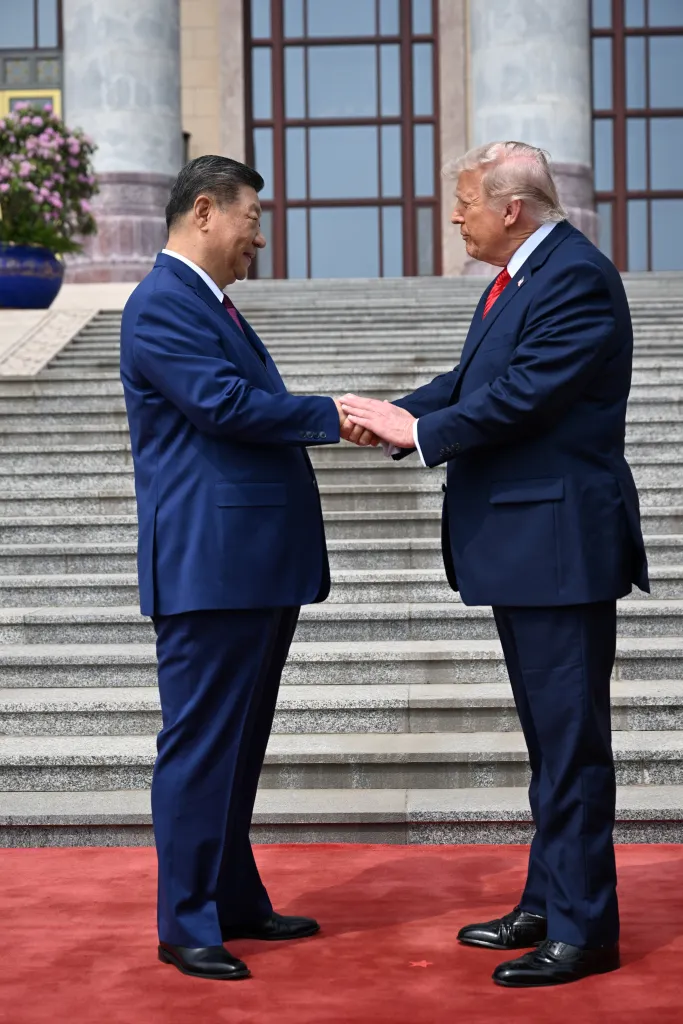 Chinese President Xi Jinping greets President Donald Trump at the Great Hall of the People in Beijing on May 14, 2026.