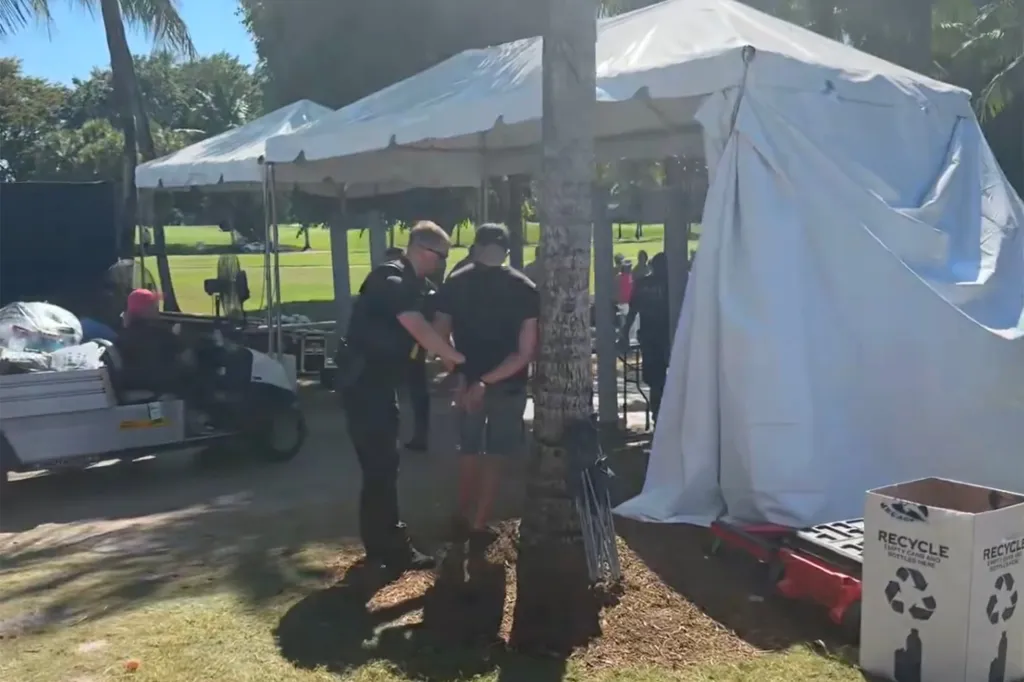 A Secret Service agent handcuffs a protester who set off magnetometers at Trump National Doral in Florida.