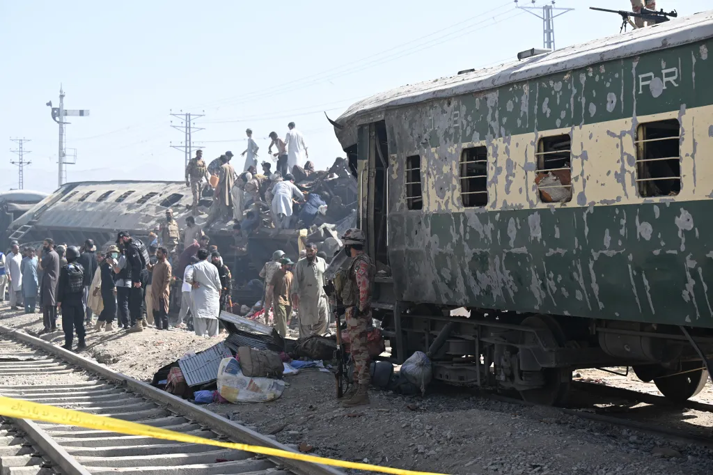 Security personnel inspect damaged derailed carriages after an explosion targeted a train in Quetta on May 24, 2026.