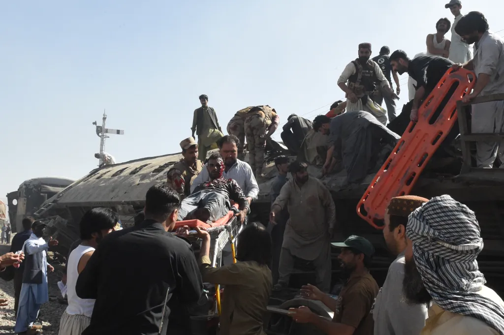 Security personnel and residents rescue injured blast victims from derailed carriages after an explosion targeted a train in Quetta on May 24, 2026.
