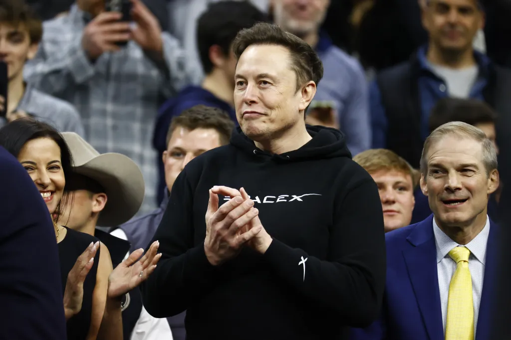 Elon Musk clapping at the Division I Men's Wrestling Championship.