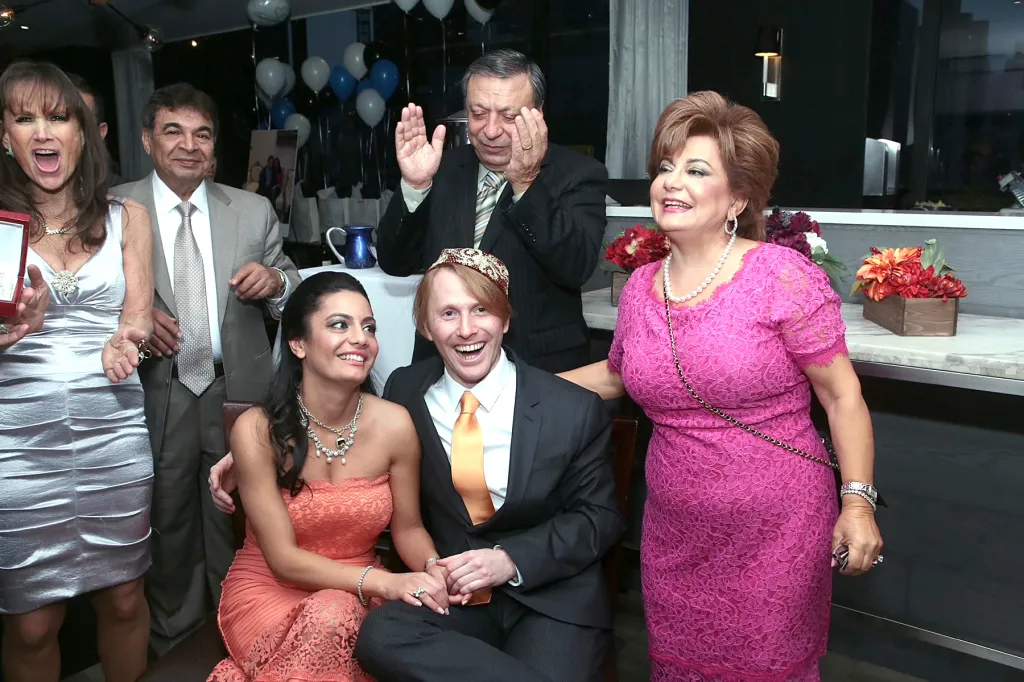 Seterah Bral and Dr. Ryan Aronin smiling with friends and family.